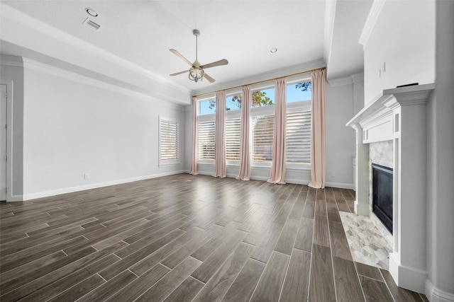 unfurnished living room with dark hardwood / wood-style floors, ceiling fan, ornamental molding, and a premium fireplace