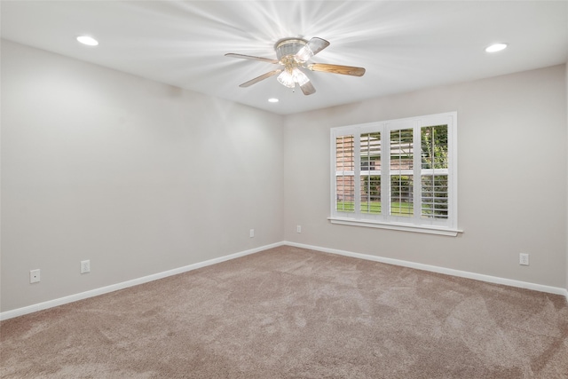 carpeted empty room featuring ceiling fan