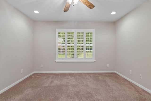 carpeted spare room with ceiling fan