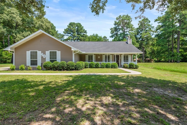 ranch-style home with a front yard and a porch