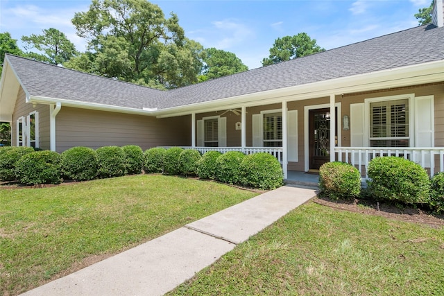 ranch-style home featuring a porch and a front yard