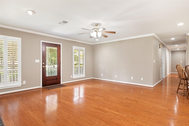 interior space featuring crown molding, ceiling fan, and light wood-type flooring