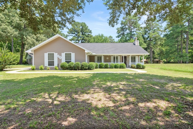 ranch-style home featuring a front yard and covered porch