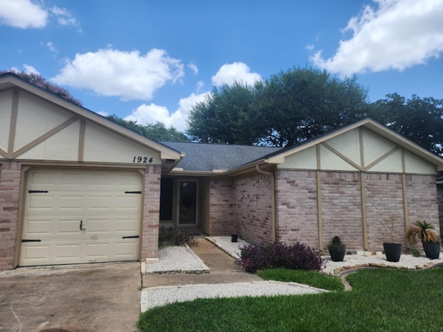 single story home with a front yard and a garage