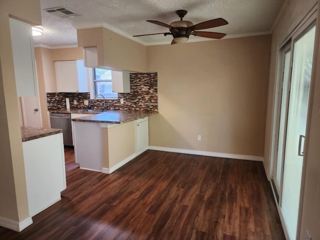 kitchen with tasteful backsplash, stainless steel dishwasher, ceiling fan, dark wood-type flooring, and white cabinets