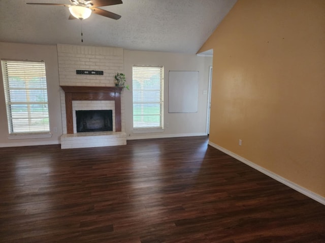 unfurnished living room with a healthy amount of sunlight, ceiling fan, and dark wood-type flooring