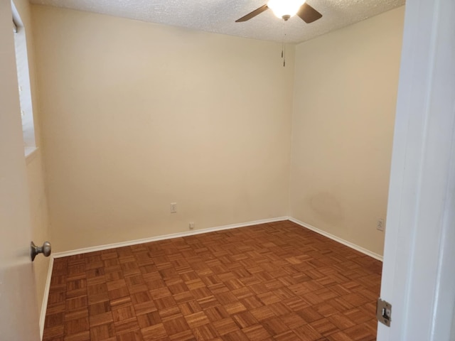 spare room with parquet flooring, a textured ceiling, and ceiling fan