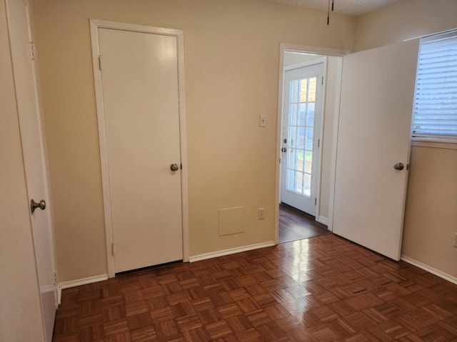 interior space featuring dark parquet flooring