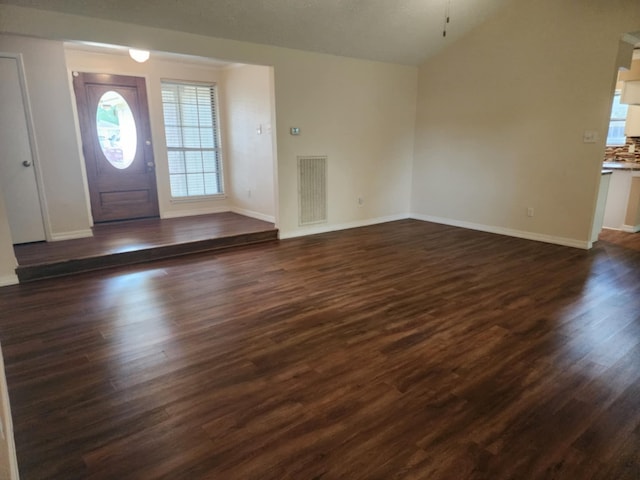 foyer with lofted ceiling and dark wood-type flooring