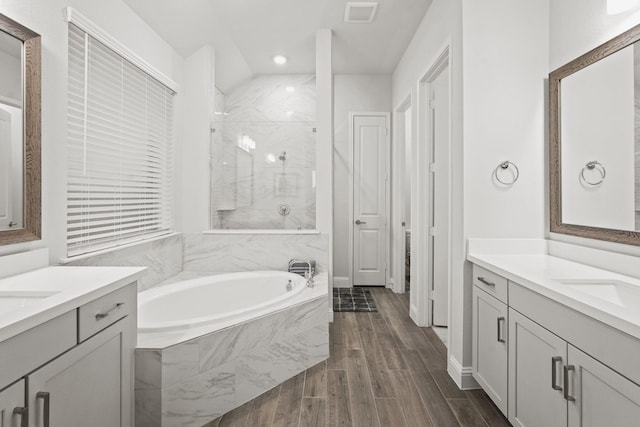 bathroom with vanity and separate shower and tub