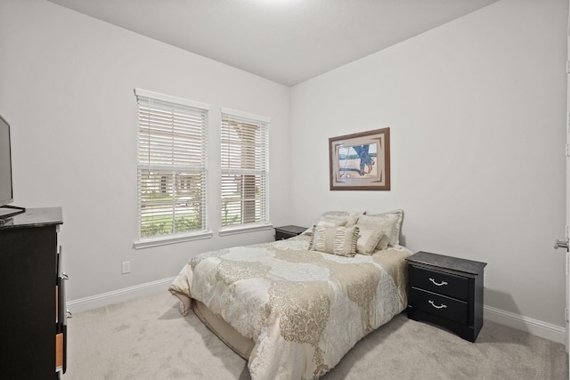 bedroom featuring light colored carpet