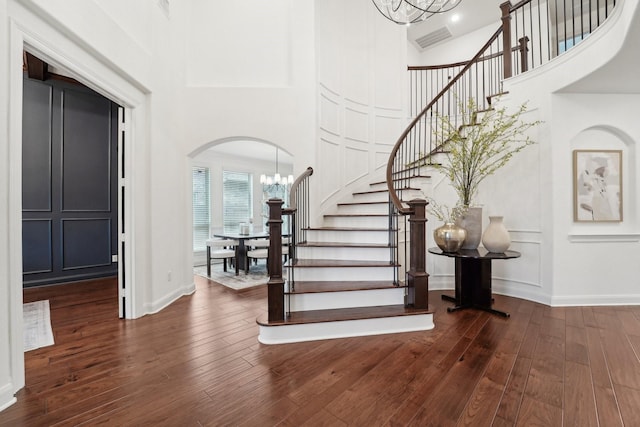 foyer with a chandelier, dark hardwood / wood-style floors, and a high ceiling