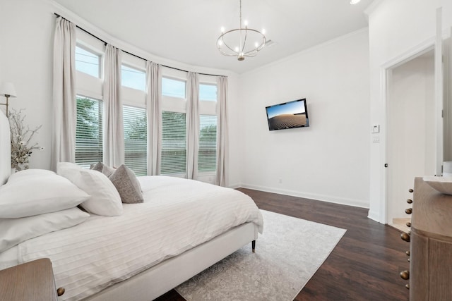 bedroom featuring ornamental molding, dark hardwood / wood-style floors, and a notable chandelier