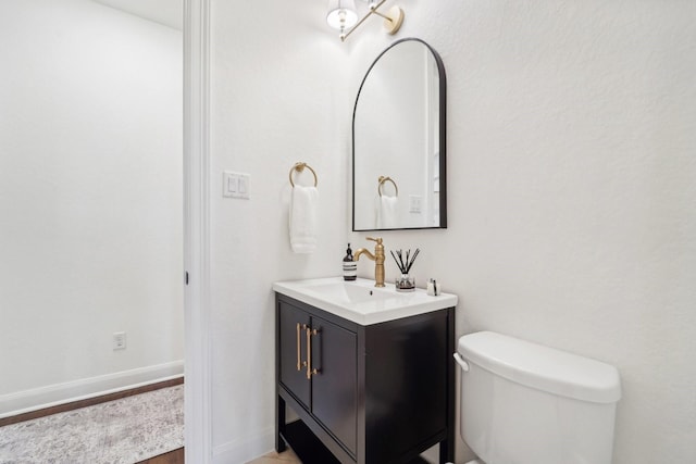 bathroom featuring vanity, toilet, and wood-type flooring