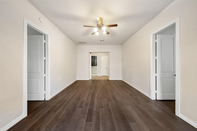 spare room with ceiling fan and dark hardwood / wood-style flooring