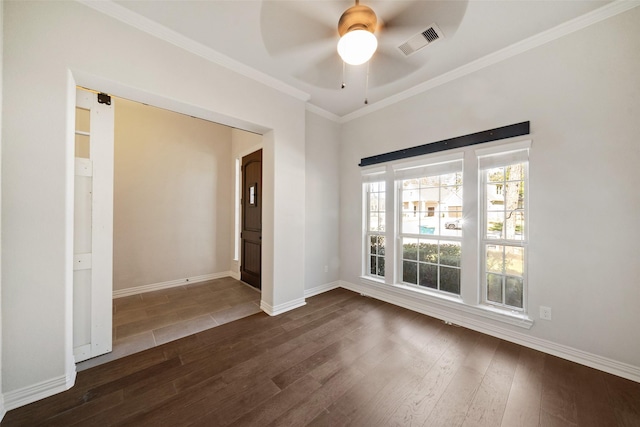 spare room with ceiling fan, ornamental molding, and dark wood-type flooring