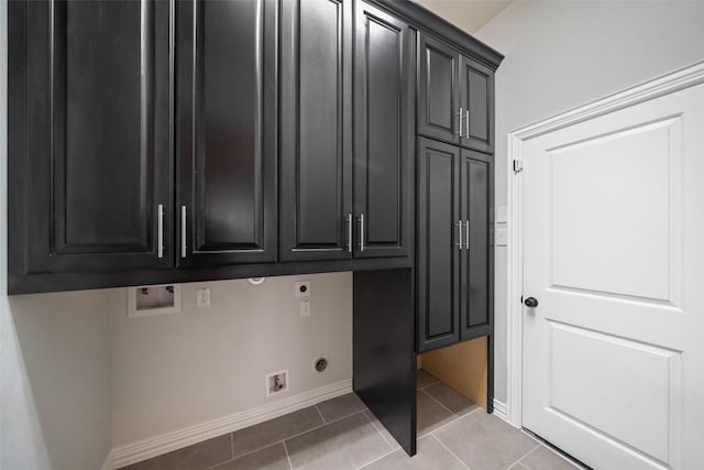 clothes washing area featuring electric dryer hookup, light tile patterned floors, cabinets, and washer hookup