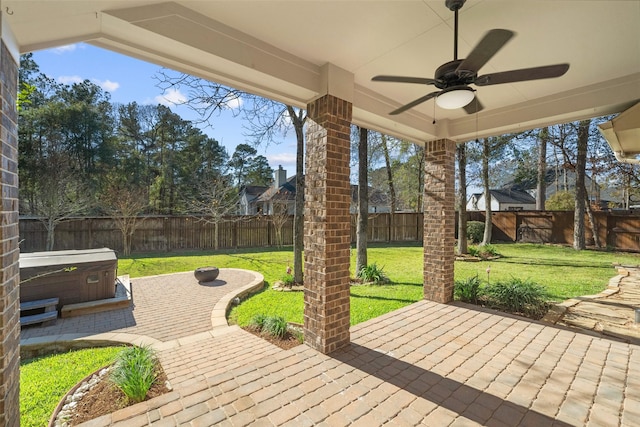 view of patio / terrace with a hot tub and ceiling fan