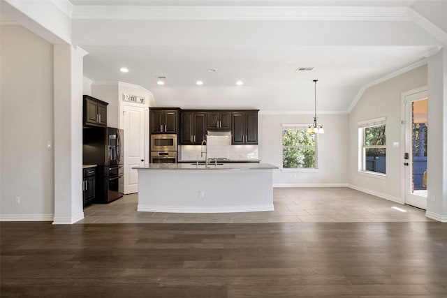 kitchen with appliances with stainless steel finishes, a kitchen island with sink, lofted ceiling, and sink