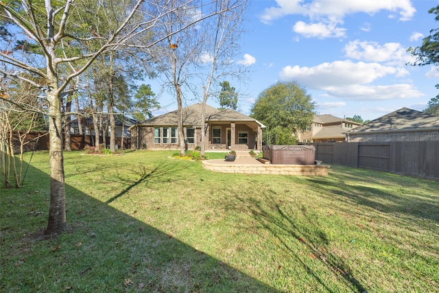 view of yard with a hot tub and a patio area