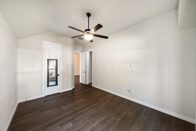 spare room with vaulted ceiling, ceiling fan, and dark wood-type flooring