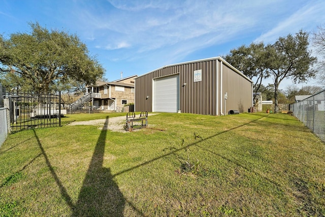 view of yard with a garage and an outdoor structure