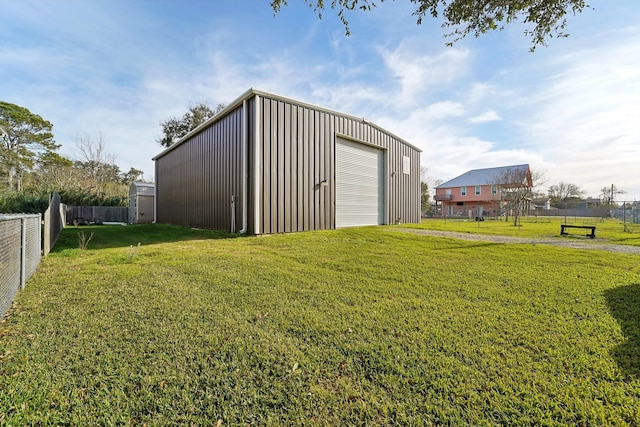 view of outdoor structure featuring a garage and a lawn