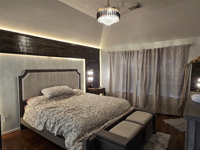 bedroom with dark wood-type flooring and a chandelier