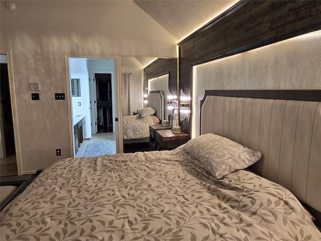 bedroom with a textured ceiling, a closet, and vaulted ceiling