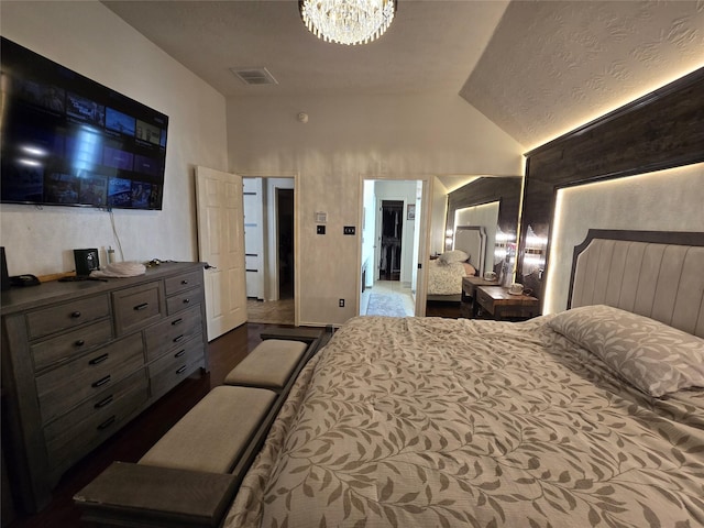 bedroom with lofted ceiling and an inviting chandelier