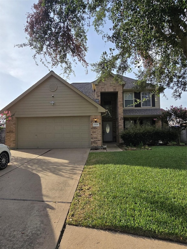 view of front facade with a garage and a front lawn