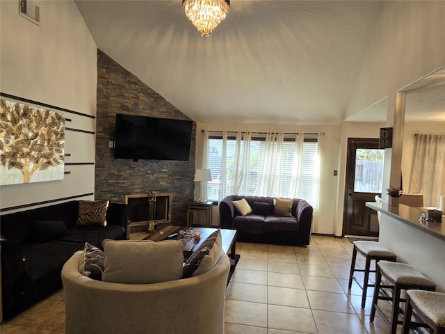 tiled living room featuring a fireplace, high vaulted ceiling, and a chandelier