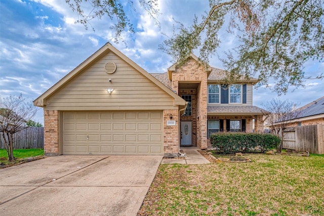 view of property with a garage and a front yard