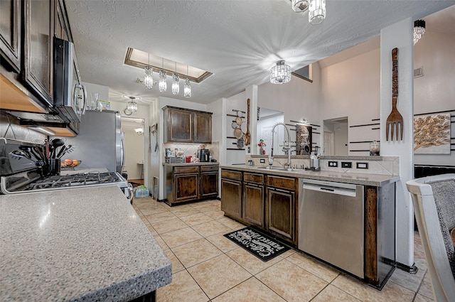 kitchen with sink, dark brown cabinets, dishwasher, decorative backsplash, and stove