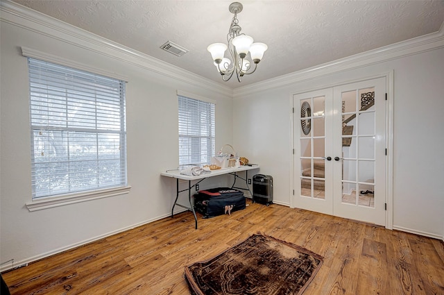 home office featuring hardwood / wood-style flooring, ornamental molding, french doors, and a textured ceiling