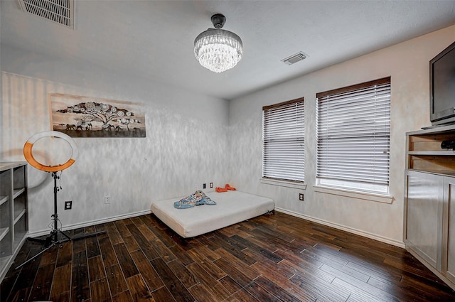 interior space with dark wood-type flooring and a chandelier