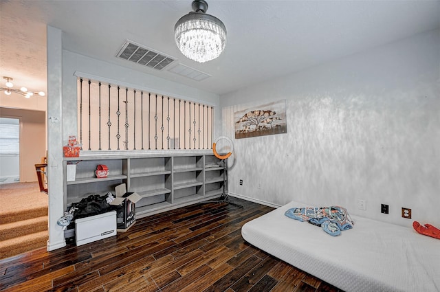 misc room with dark wood-type flooring and a chandelier