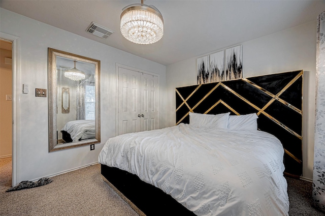 carpeted bedroom with an inviting chandelier and a closet