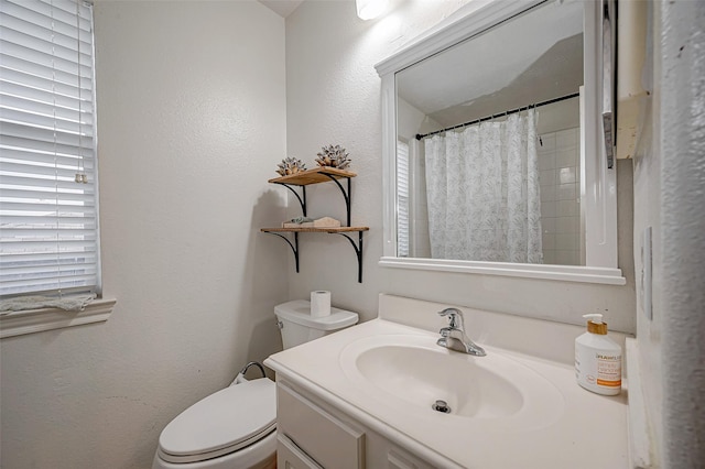 bathroom featuring a shower with curtain, vanity, and toilet