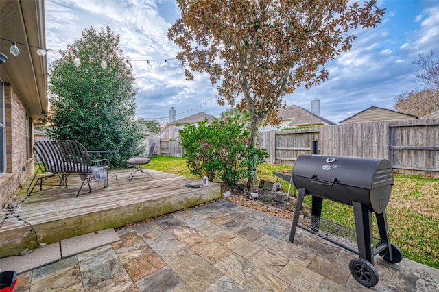 view of patio / terrace featuring a wooden deck and a grill