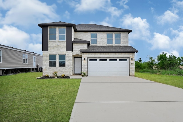 view of front of home featuring a garage and a front lawn