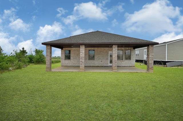 rear view of house with a patio area and a lawn