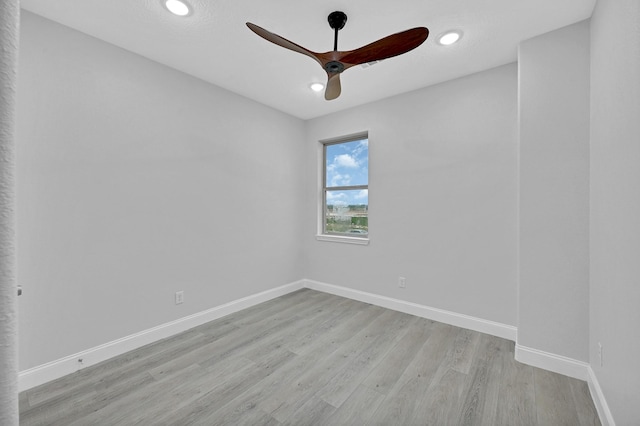 unfurnished room featuring ceiling fan and light hardwood / wood-style floors