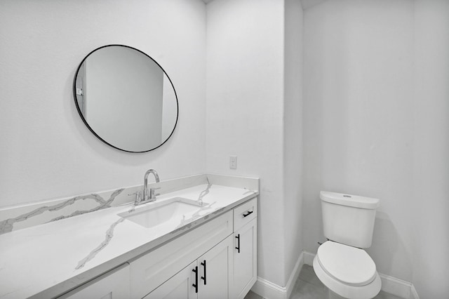 bathroom with tile patterned floors, vanity, and toilet