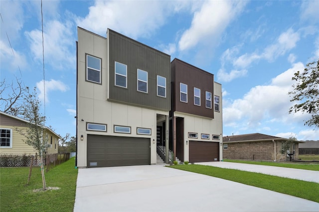 contemporary house featuring a garage and a front lawn