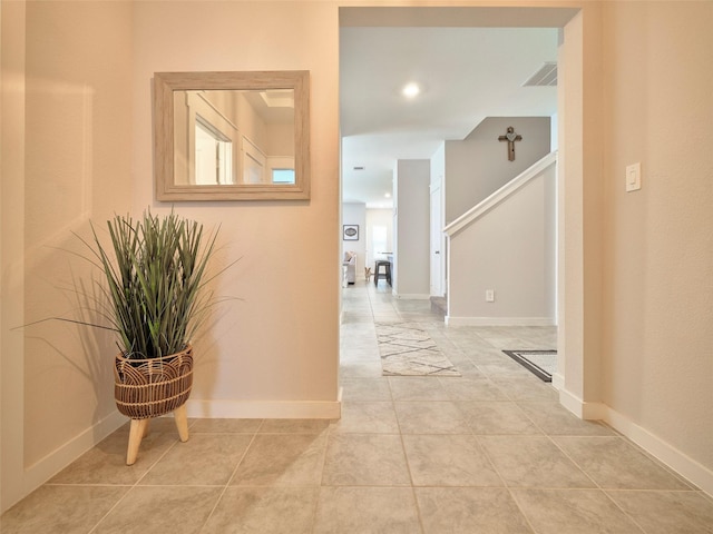 hall featuring light tile patterned flooring