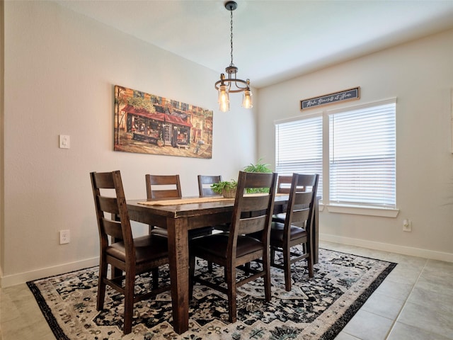 tiled dining space with a chandelier