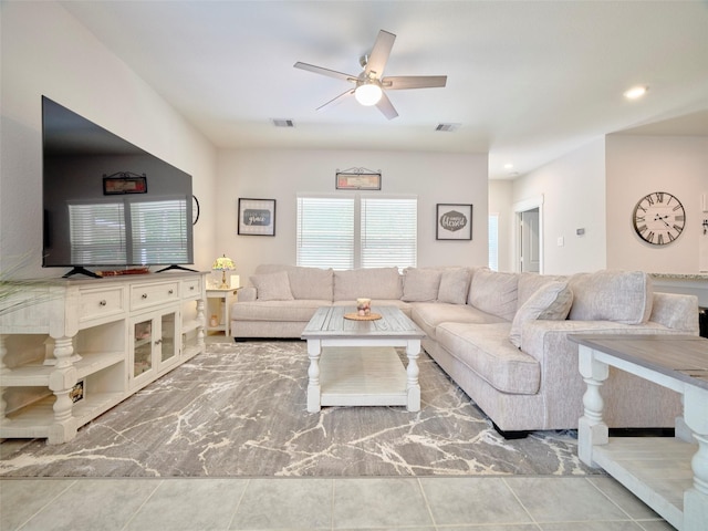 living room featuring tile patterned floors and ceiling fan