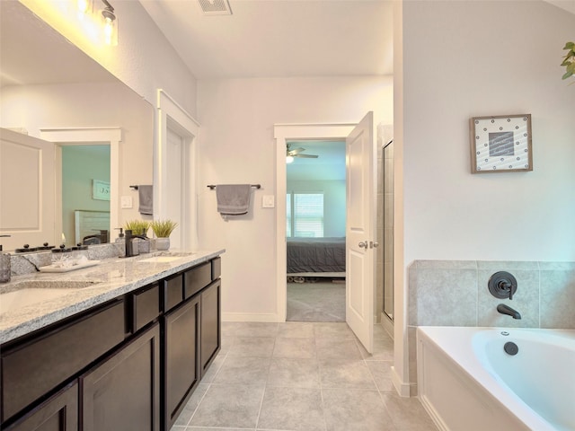 bathroom featuring vanity, tile patterned floors, ceiling fan, and a tub