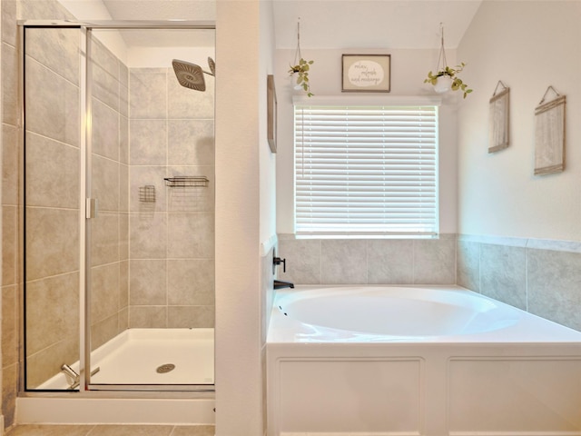 bathroom with plenty of natural light, lofted ceiling, and independent shower and bath